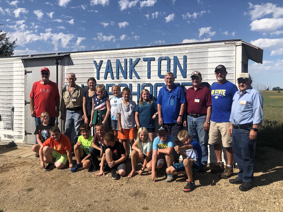 Youth shooters and instructors outside the club building
